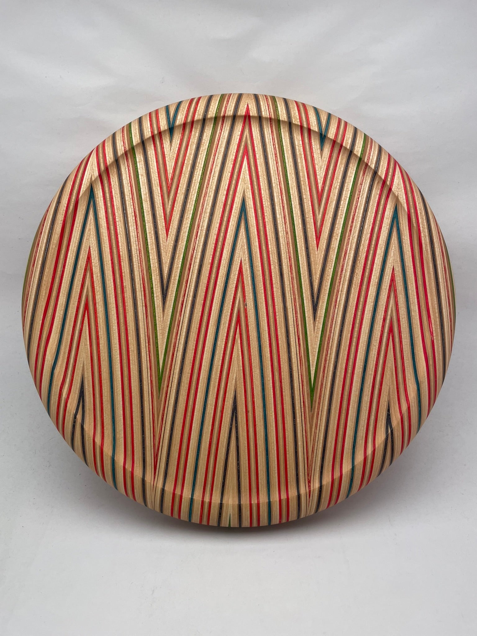 Beautiful and playful bar stool seat. made of skateboard wood layers. Top view.
Fits on most supports with round top structure.