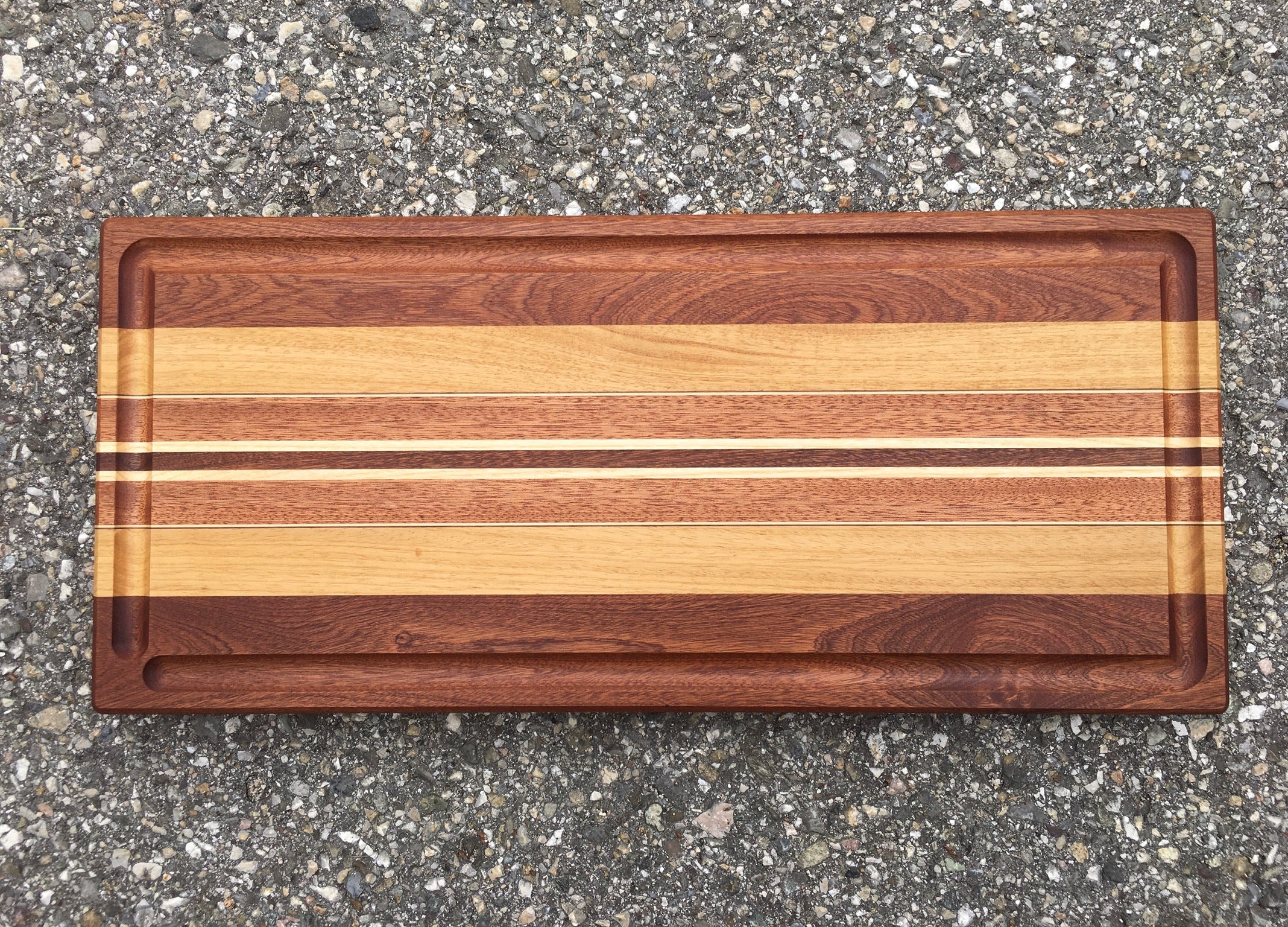 Multicolored Chopping board with linear marquetery.  Directly inspired by our Longboard. 